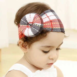 Detalle de diadema para bebé de cuadros rojos y negros con nudo redondo muy suave