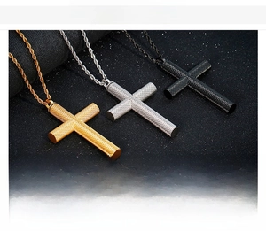 Close-up of cross pendants in gold, silver, and black with knurled mesh texture