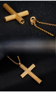 Detail of gold stainless steel cross pendant with textured pattern and opening feature
