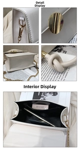 Detail view of white leather crossbody bag with gold hardware and internal storage space