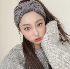 Detailed knit texture of a grey wide bow headband for women in a soft close-up view