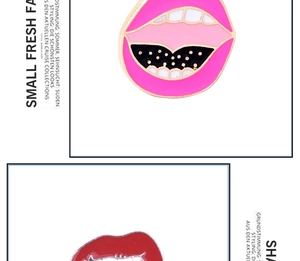 Close-up of vibrant red and pink enamel lip-shaped brooches with detailed gold accents