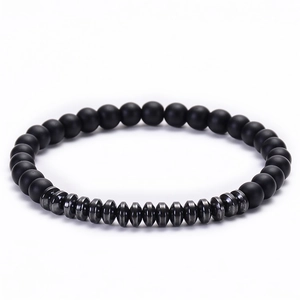 Detail view of matte black agate beads and metallic hematite accents on a beaded bracelet