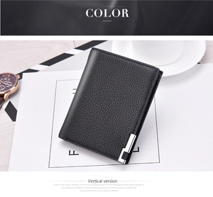 Detailed view of black pebble leather men's wallet with silver accent and business accessories