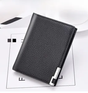 Macro shot of men's bifold wallet in black litchi grain leather with metal detail