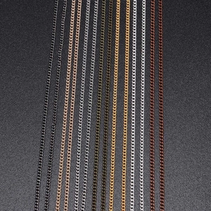 Detail of DIY fine metal chains in eight plating colors on a black textured background