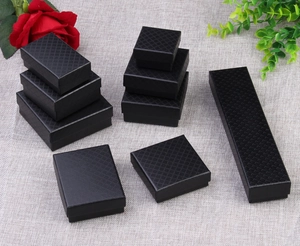 Macro view of black diamond pattern jewelry boxes in multiple sizes for rings and necklaces