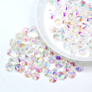 Macro shot of iridescent AB round rhinestones for nail art in a white container