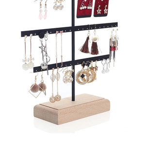 Detail of multi-tier black metal earring organizer with a solid wooden base display
