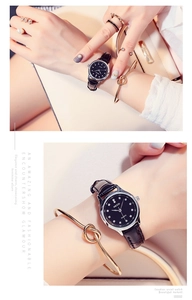 Elegant KEZZI women's watch with black rhinestone dial and textured leather strap on wrist