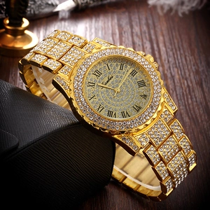 Detail view of luxury gold quartz watch encrusted with brilliant crystal rhinestones