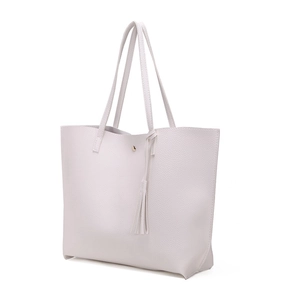 Detail shot of off-white lychee texture tote bag with tassel and gold magnetic buckle