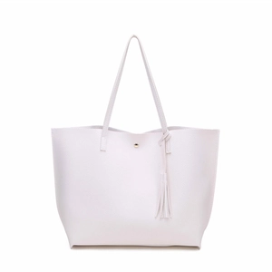 Close-up of white lychee texture tote bag featuring golden stud closure and fringe tassel