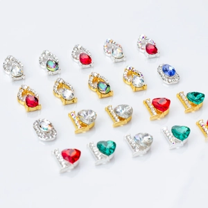 Assorted colorful crystal nail art charms in heart and drop shapes with metal bases