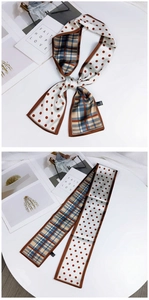 Detailed view of dual-sided twilly scarf featuring coffee polka dots and blue plaid pattern