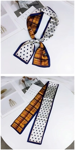 Detail of double-sided twilly scarf featuring blue polka dots and orange plaid pattern