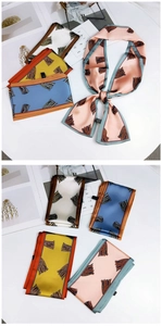 Close-up of four colors of long satin ribbons with abstract fringe patterns and contrast edges