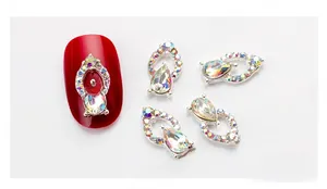 Detail of teardrop AB crystal nail charm with silver alloy frame and pavé small rhinestones