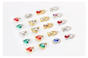 Macro detail of colorful heart and teardrop crystals with gold and silver alloy bases