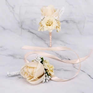 Close-up of champagne silk rose boutonniere and wrist corsage set for weddings