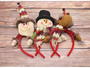 Detailed close-up of Santa, snowman, and reindeer headbands on dark wood background