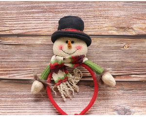 Detailed view of Christmas snowman headband with festive scarf on a wooden background