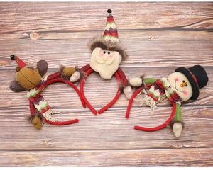 Three festive Christmas headbands featuring reindeer, Santa, and snowman on a wood background
