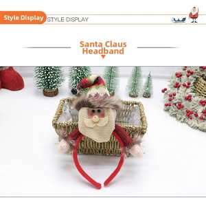 Detail of Christmas headband with plush Santa Claus figure and knitted hat decoration