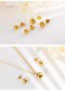 Detailed view of polished golden bead stud earrings and matching pendant necklace set