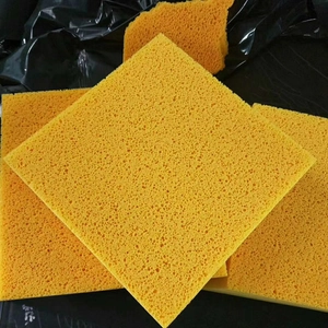Close-up of three yellow square cellulose sponges with porous texture for facial cleansing