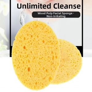 Macro detail of two yellow round facial sponges with a natural wood pulp honeycomb texture