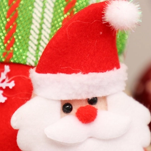 Close-up of Santa Claus plush applique with white beard and red hat on Christmas stocking