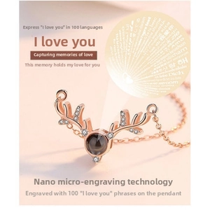 Macro shot of rose gold reindeer pendant featuring nano-engraved I Love You projection
