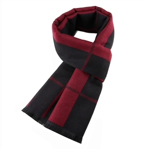 Detail of red and black checkered scarf texture with elegant fringed edges