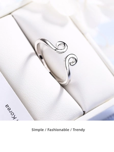 Macro shot of silver adjustable open ring with engraved cloud pattern in a gift box