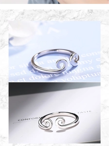 Detailed top view of silver Monkey King bar ring with spiral ends and inlaid diamond detail