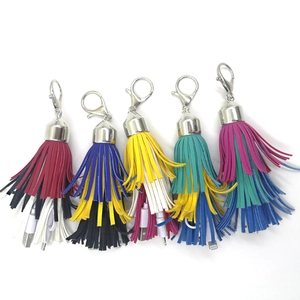 Detail of colorful PU leather tassel keychains featuring integrated USB charging cables