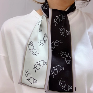 Detail of a black and white twilly scarf featuring minimalist female line art on a neck