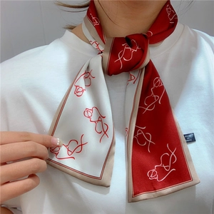 Detailed close-up of burgundy and beige artistic silk scarf with abstract line art pattern