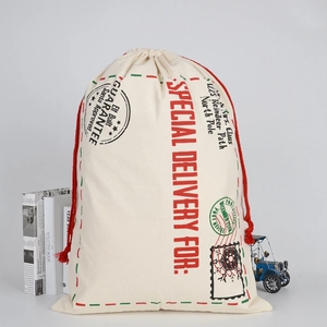 Detailed view of canvas Santa Sack with red drawstring and vintage stamp print design