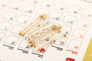 Close-up of 7-piece rose gold industrial barbell set with heart and arrow designs