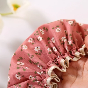Pink double-layer waterproof floral shower cap with elastic satin edge detail