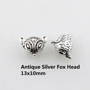 Detailed close-up of antique silver fox head beads for DIY jewelry measuring 13x10mm