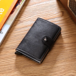 Detail view of black textured leather RFID card holder with automatic pop-up mechanism