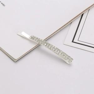 Detail of silver bobby pin featuring double-row crystal rhinestones on polished metal