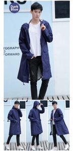Detail of dark blue waterproof raincoat featuring a zipper closure and flap pockets