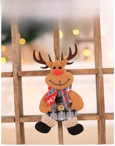 Detail view of plush reindeer ornament with red nose and checkered trousers on a tree