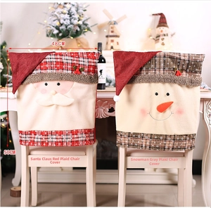 Detail of Christmas chair covers featuring Santa and Snowman motifs in red plaid fabric