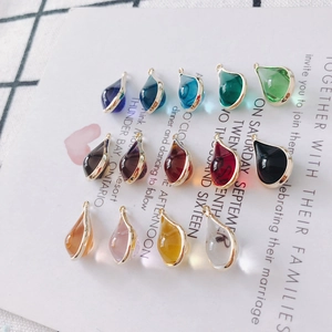 Macro shot of colorful rhinestone teardrop pendants with gold plated edges for DIY earrings