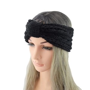 Macro shot of black cable-knit headband with twist design and chunky wool texture